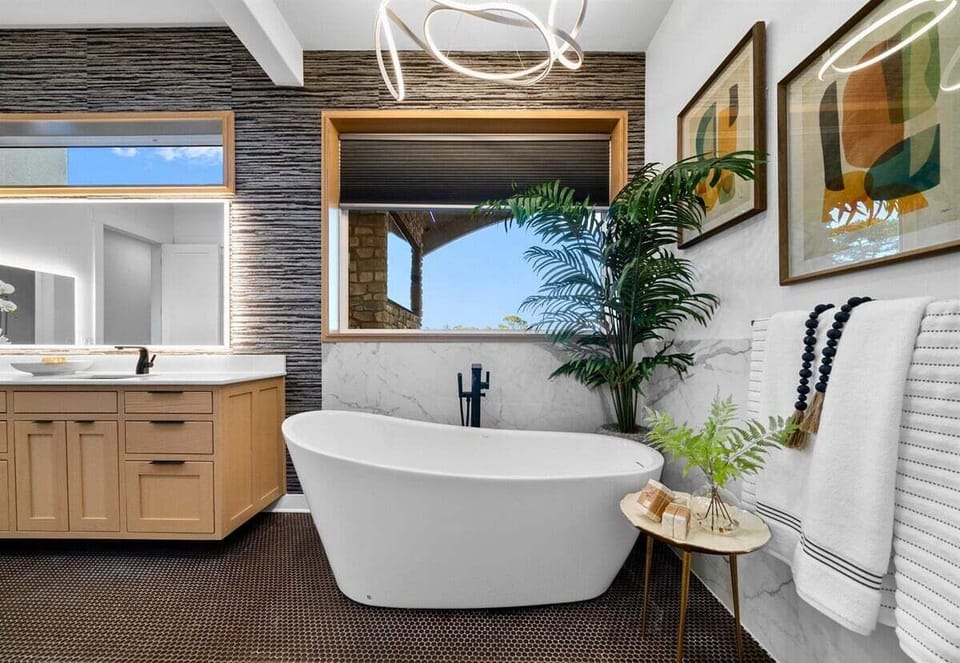 Soak up relaxation in this chic bathroom, where modern meets nature. Unwind in the standalone tub with a view