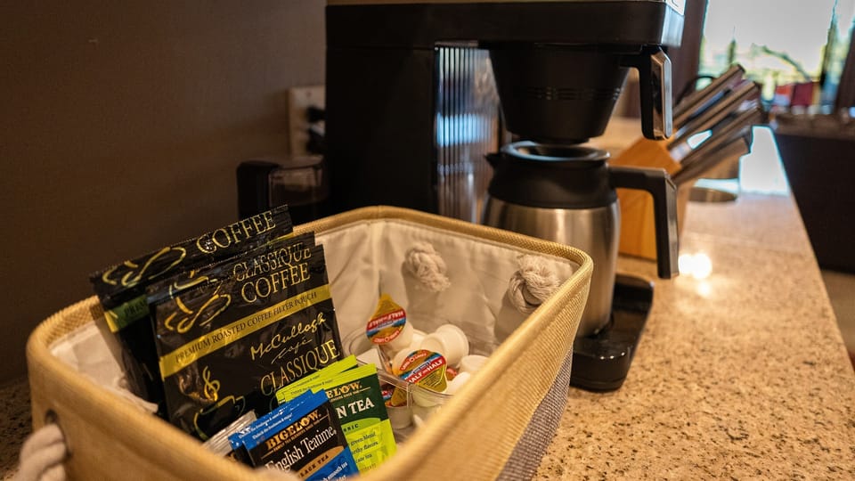 Starter coffee, tea, and creamers. Full-size Bunn coffee maker with carafe keeps coffee hot and fresh for hours! Coffee grinder included if you prefer to bring your own beans.