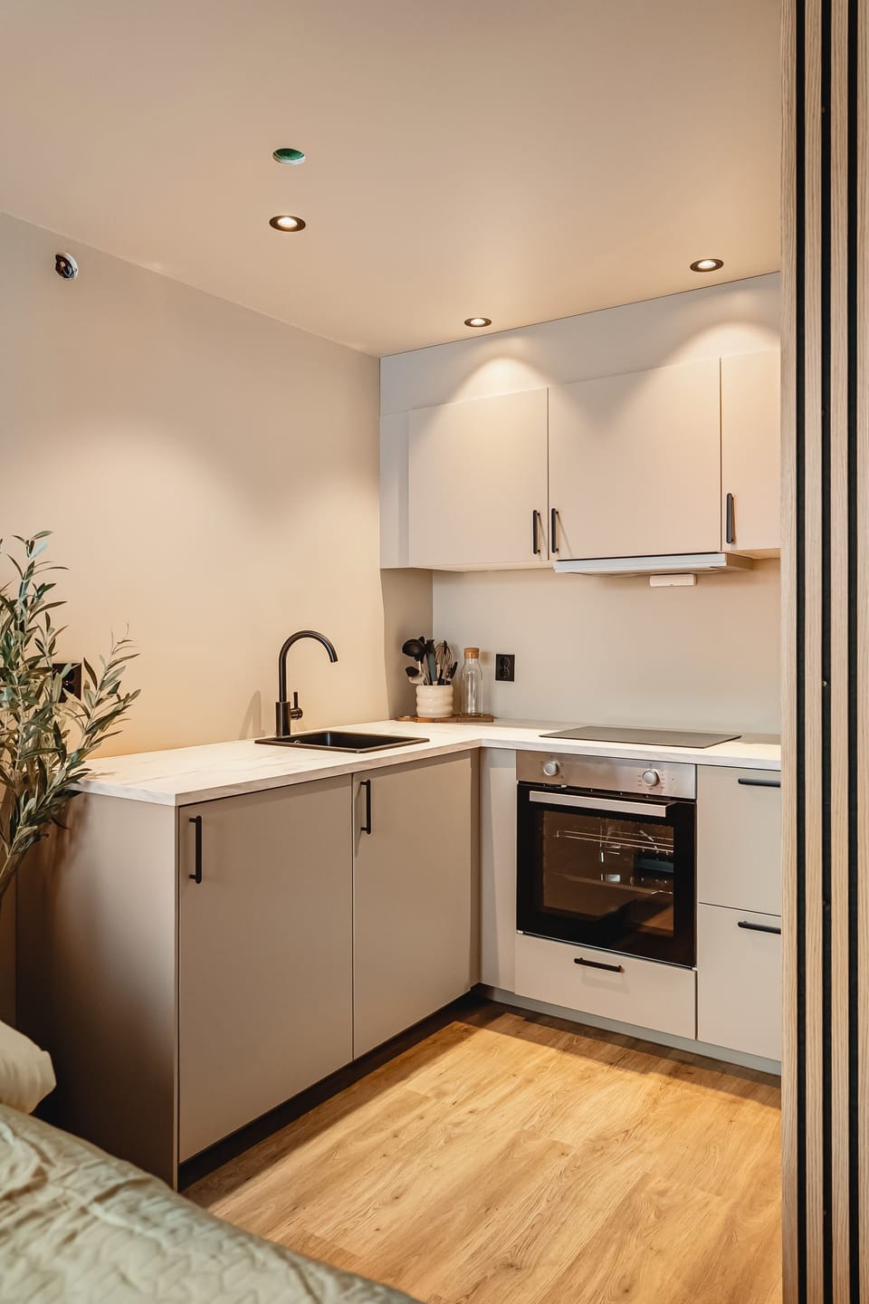 Compact kitchen with sleek surfaces and integrated appliances