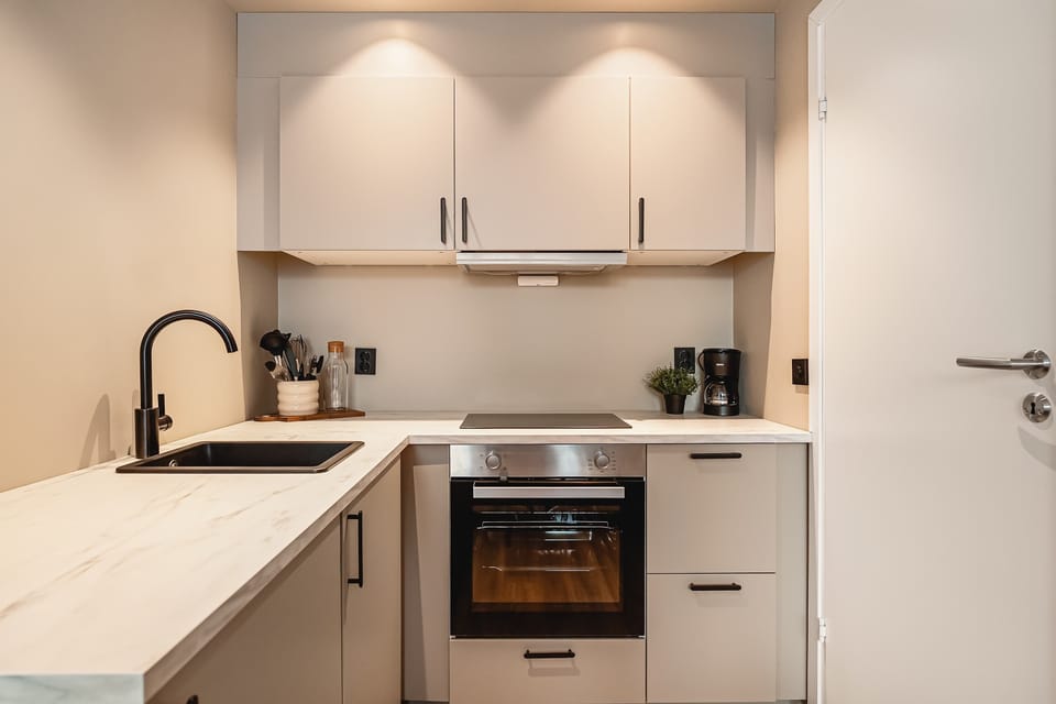 Well-lit kitchen space with open shelving and warm tones