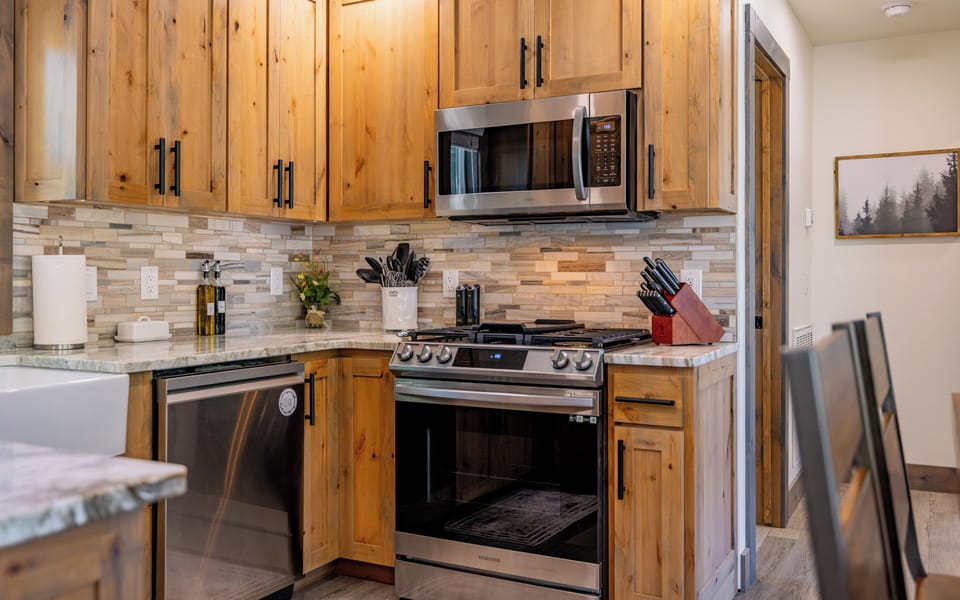 Kitchen with brand new stainless steel appliances.