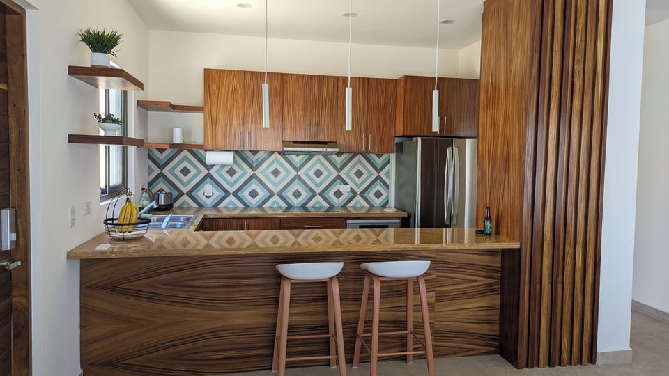 Kitchen with cooktop, microwave, oven, dishwasher, coffee maker, and toaster