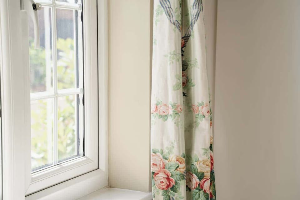 Bedroom 2: the cottage is light, bright and airy, with views out on to greenery.