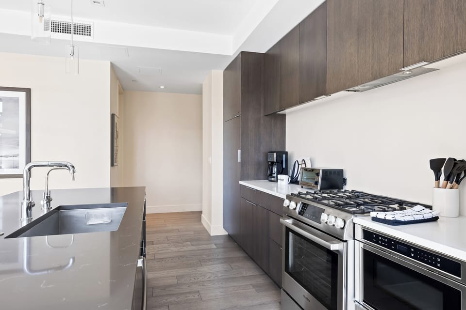 - Fully equipped kitchen with stainless gas range and coffee maker  
- Ample counter space and modern cabinetry for extended stays  
- Open layout designed for easy cooking and family gatherings