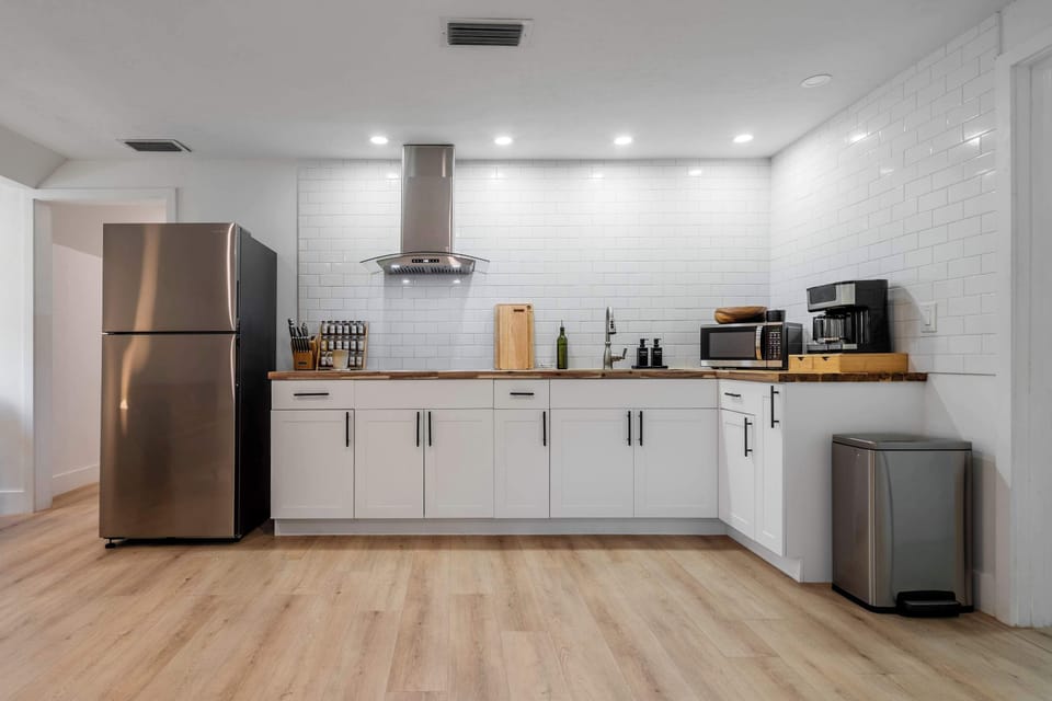 Cook with ease in our bright, modern kitchen. Featuring sleek stainless steel appliances, ample butcher block counter space, and a full subway tile backsplash, this space is as functional as it is stylish.