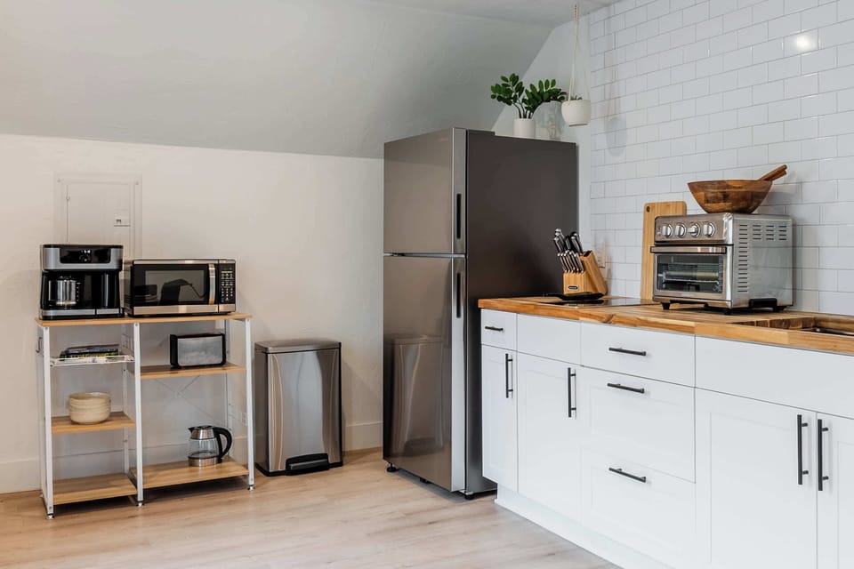 Sleek Modern Kitchenette Enjoy the perfect blend of style and convenience in our sun-drenched kitchen. With clean lines, warm wood accents, and high-end stainless steel appliances, it’s as beautiful as it is functional.