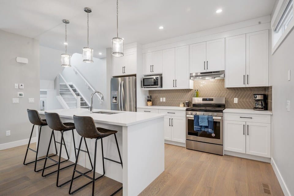 Entertain with the large kitchen island. A gas stovetop and fully stocked kitchen