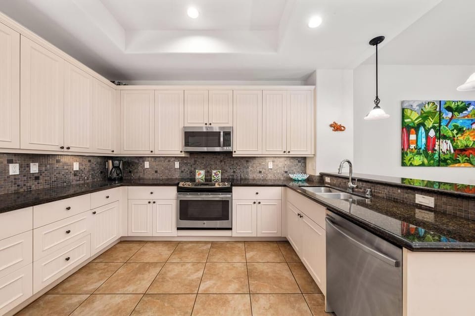 Full kitchen with granite countertops, stainless steel appliances, and breakfast bar