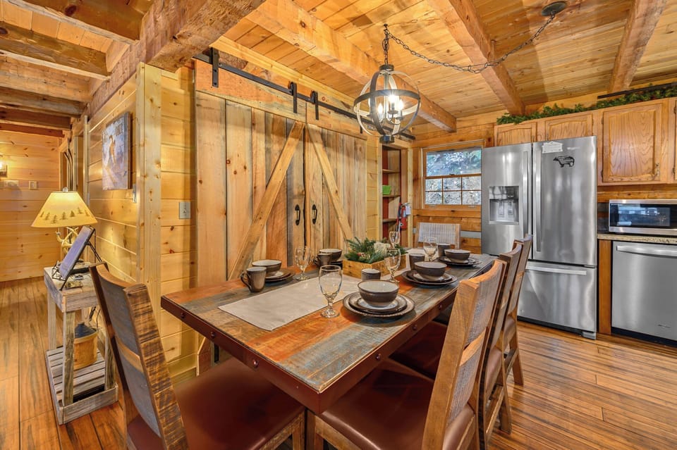 Dining table for 8 guests with 3 bar stools and the living room for family meals