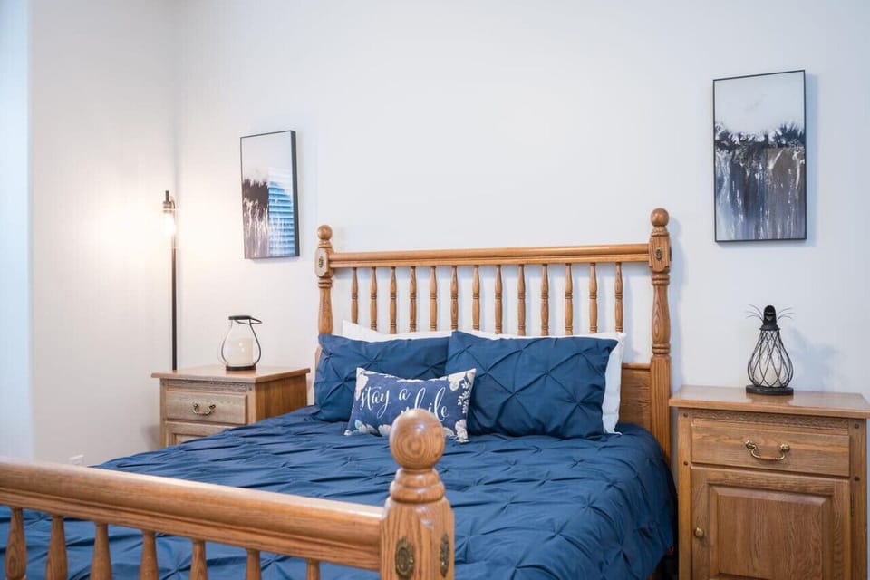 Downstairs queen bedroom with smart tv and walk in closet