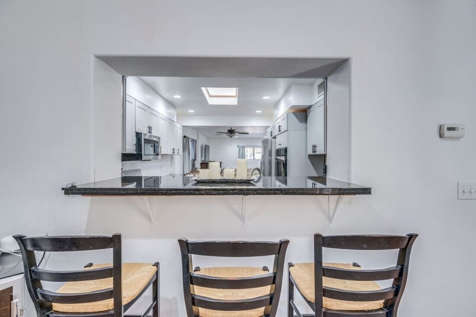 Seating at bar area with a view of the kitchen