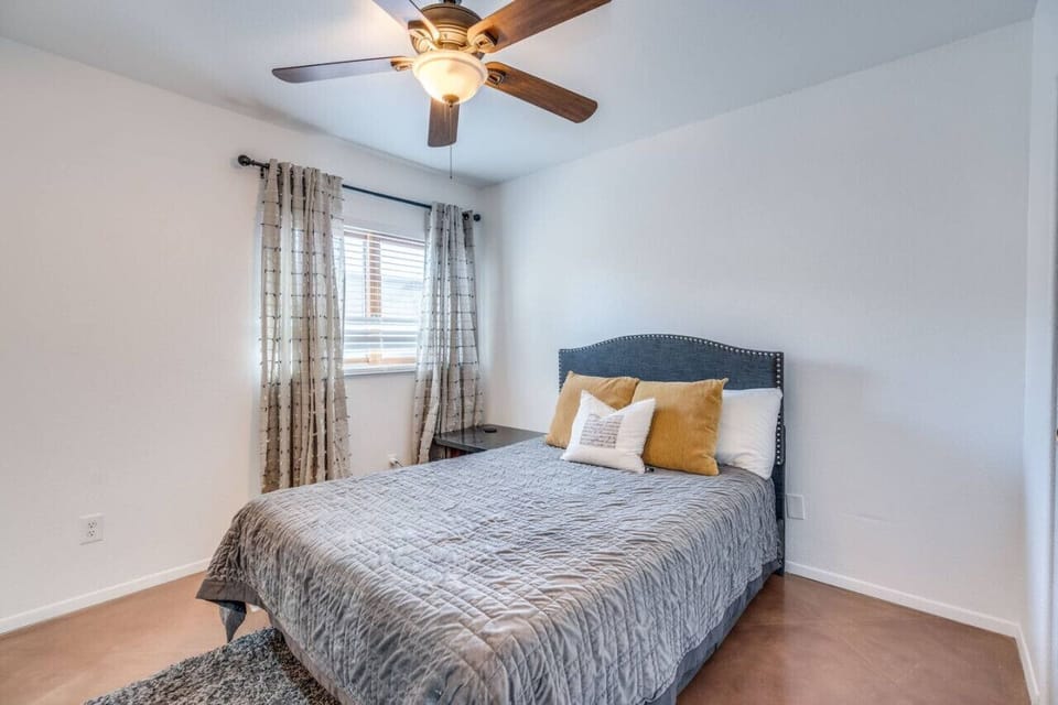 Bedroom 5 with queen-size bed, bedside table, and large closet