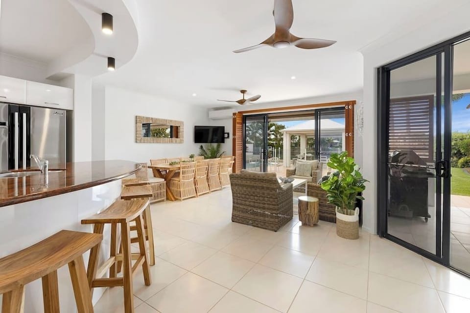 Open space floor plan - kitchen, dining, living area leading to back yard. 