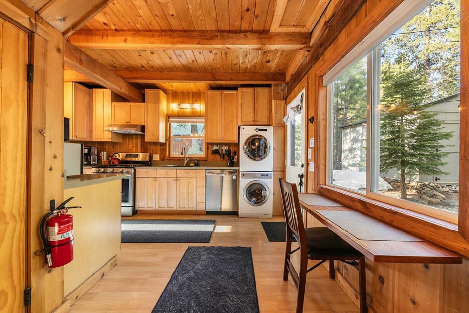 The kitchen includes a table and chair tucked under the window, a lovely spot to enjoy your morning coffee, or do some work, while taking in the views.