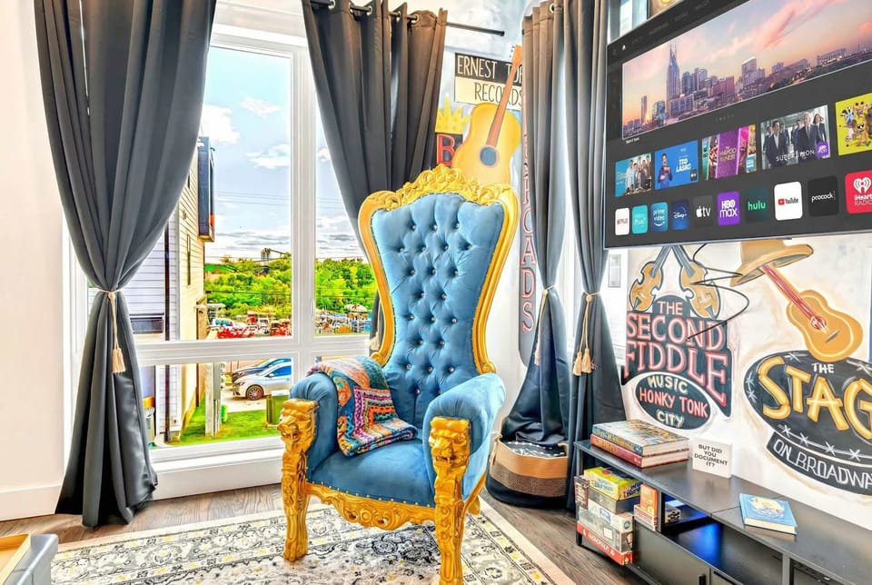 Gold throne chair by the window in the music-themed living room, a bold spot to settle in before heading out to Broadway
