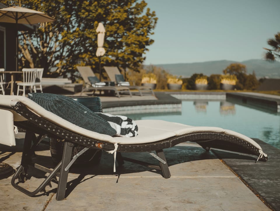 Relax by the poolside with stunning views and cozy loungers.