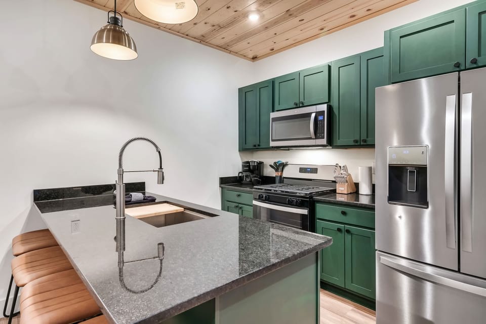 Modern design meets functionality with sleek appliances and elegant prep space!