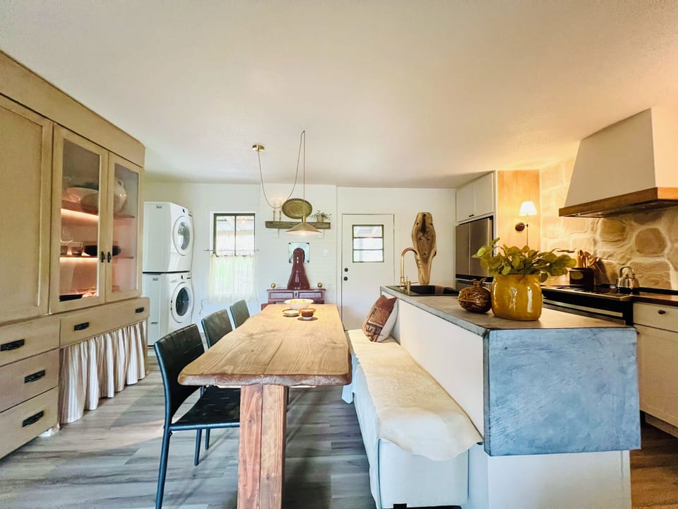 Eat-in kitchen with large dining table and banquette seating, seats 6-8 people