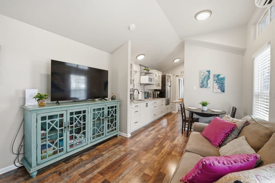 Living room with smart TV, cozy seating, and thoughtful design for relaxing nights in.