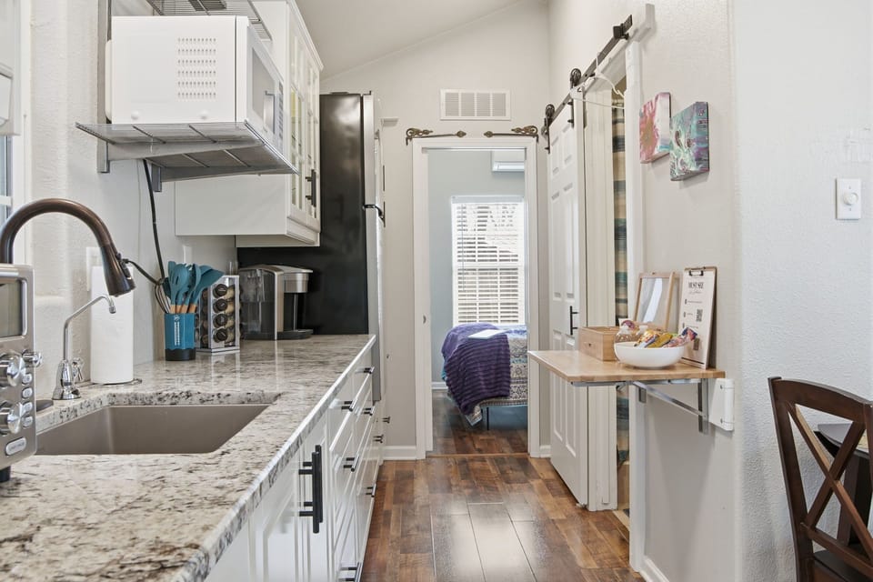 Bright kitchen space with ample counter space, stocked cabinets, and everything needed for home cooking.