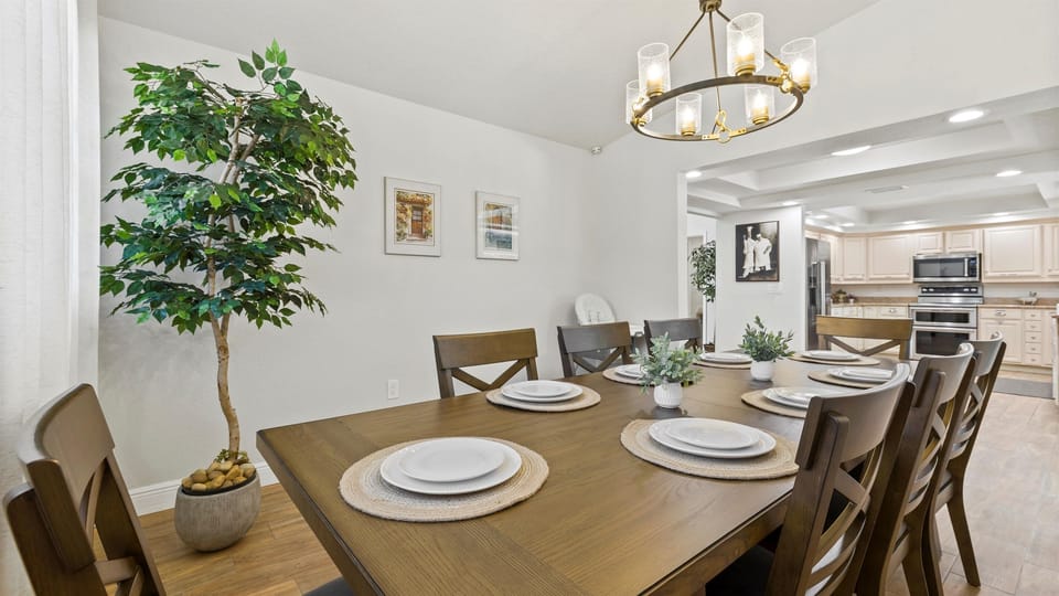 Gather around this elegant 8-seat dining table in a beautifully lit space featuring stylish décor, wood flooring, and a warm ambiance. Located just off the fully equipped chef’s kitchen, it’s ideal for family dinners, game nights, or hosting friends during