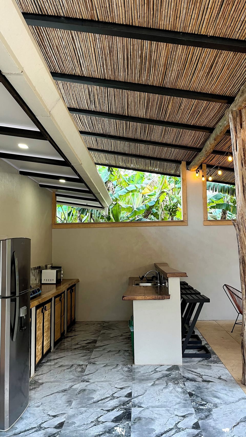 Fully equipped kitchen with fridge, stove, microwave, coffee maker & dishes.