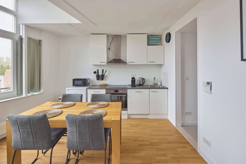 Open-plan apartment with modern furnishings and a light, airy feel.