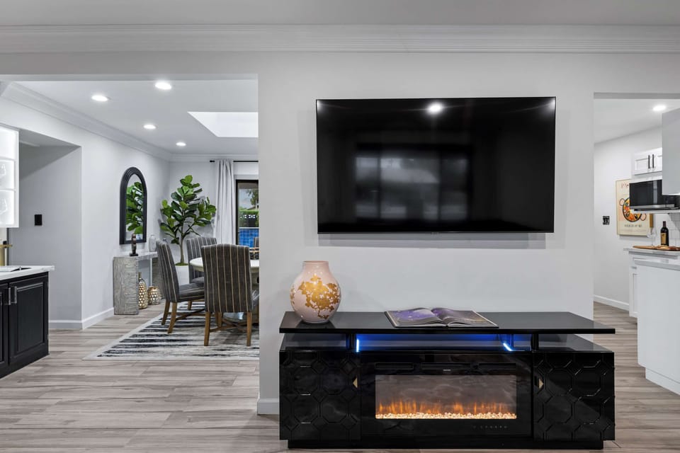 Sleek entertainment area with an electric fireplace.