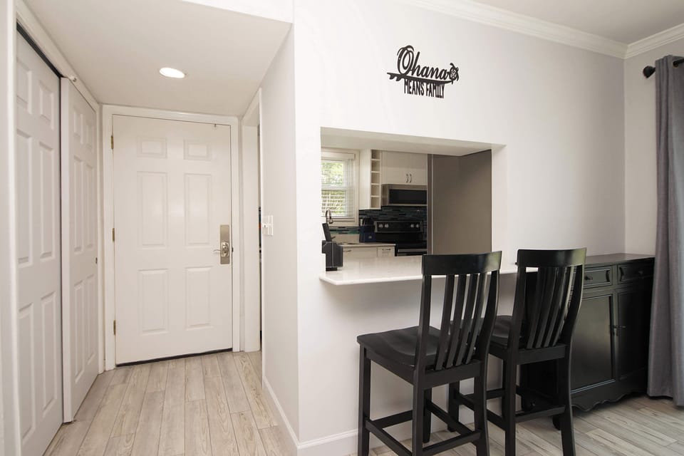 You'll love gathering around your breakfast bar with its sleek black stools, perfectly positioned near the modern kitchen for easy morning coffee and conversation.