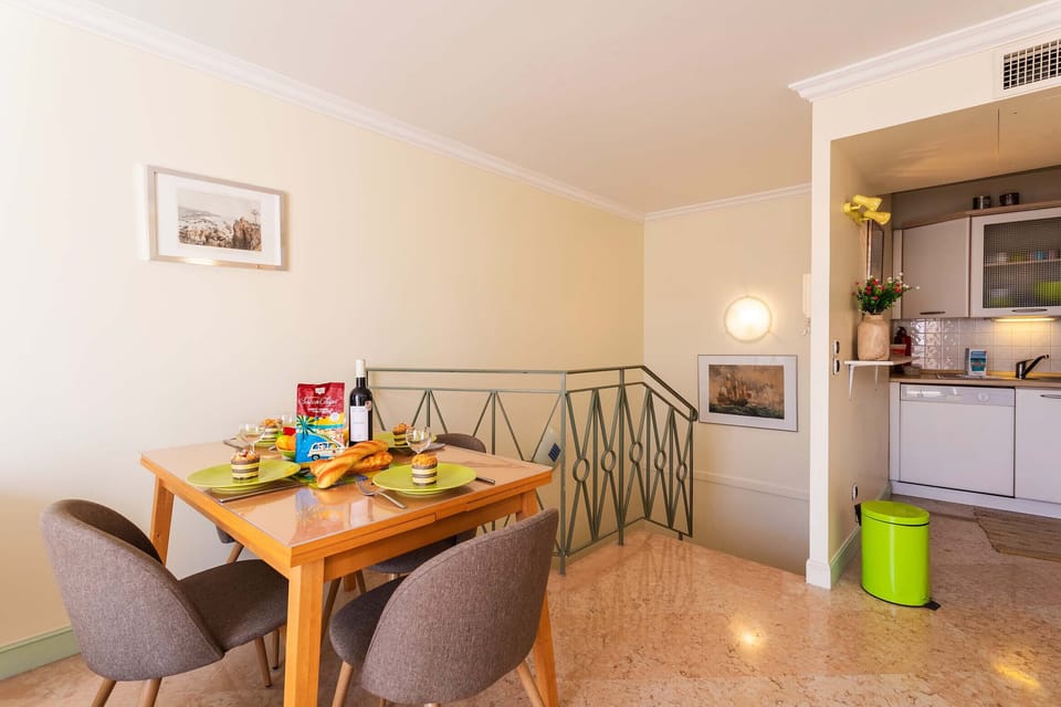 Bright and elegant dining area featuring a beautifully set table. Ideal for hosting meals in a serene and sophisticated setting.