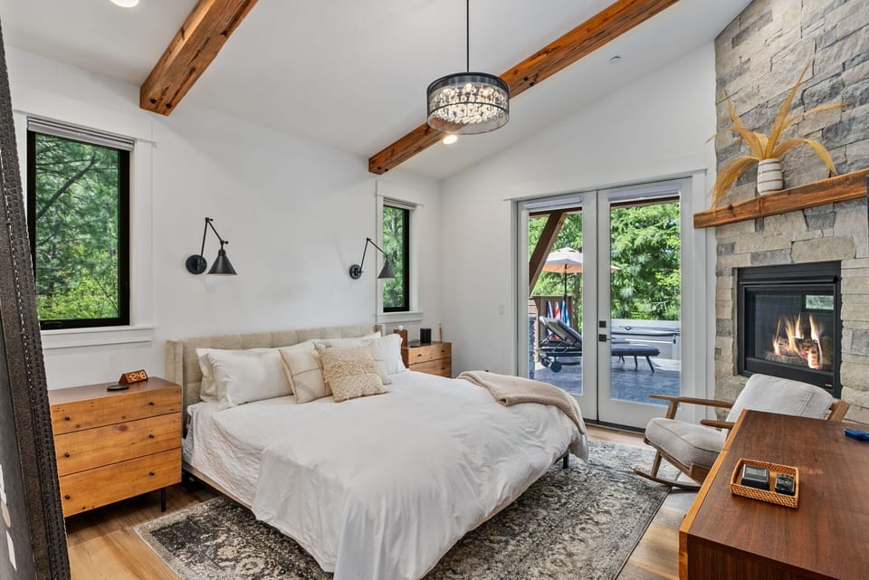 Main Floor - Bedroom 1, Master Suite King Size Bed, En-Suite Bathroom, Gas Fireplace + Statement Lighting for Restful Luxury