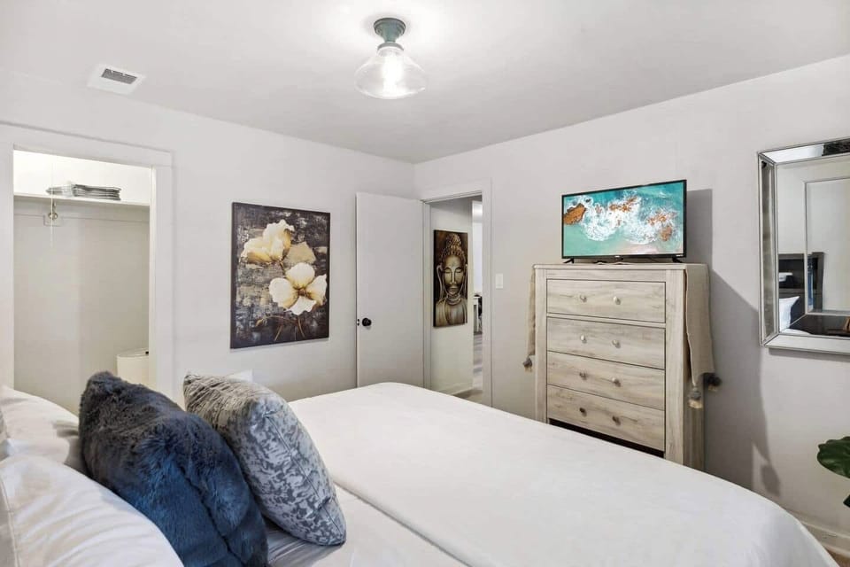 King bedroom is off the hallway and also has dresser, smart tv and closet