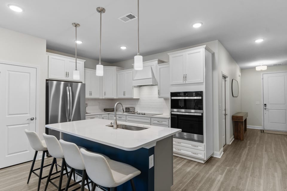 Modern full kitchen with island seating perfect for group stays in Barefoot Resort