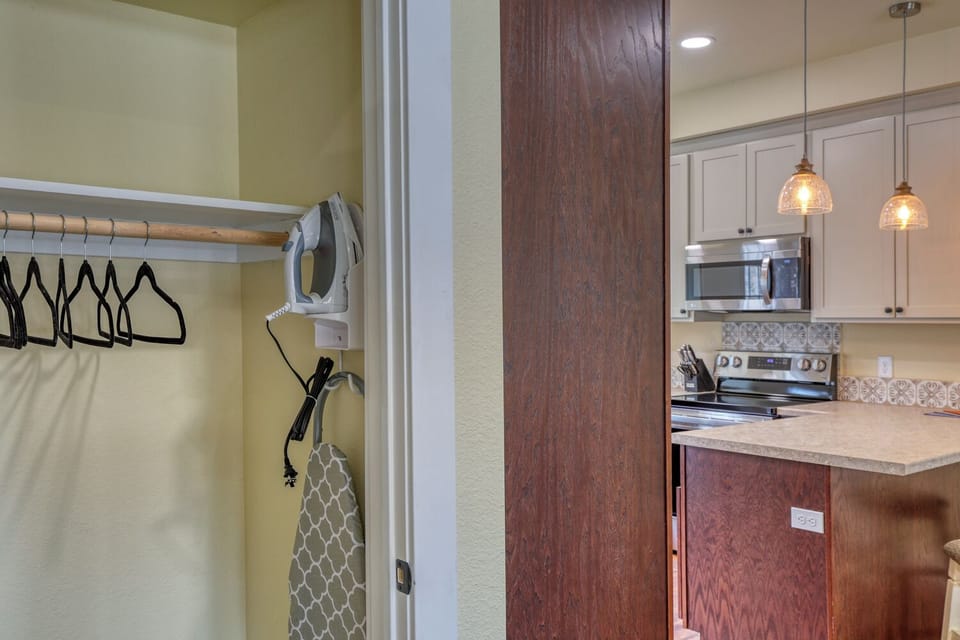 Countertop ironing board and iron stored in the living room closet.