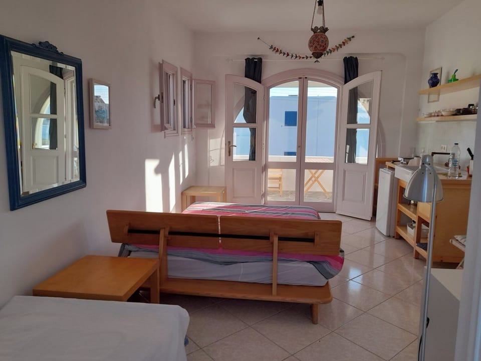 Lovely bedroom with double bed and single bed,two balconies and a small kitchen 