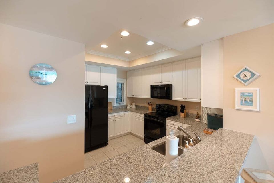 Modern kitchen fully stocked with cookware, appliances, Keurig and standard coffee makers, and everything needed for cooking and hosting during your stay