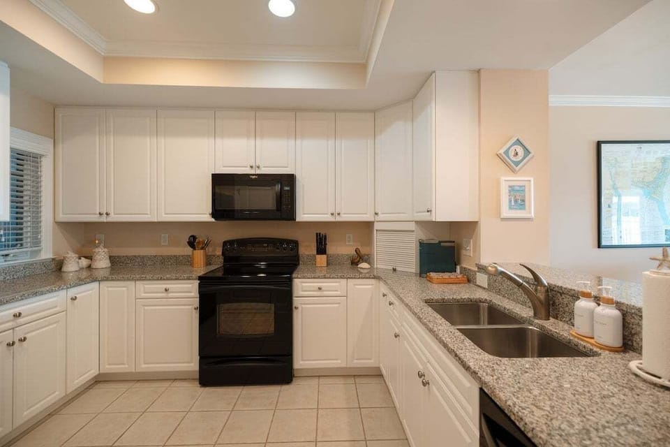 Modern kitchen fully stocked with cookware, appliances, Keurig and standard coffee makers, and everything needed for cooking and hosting during your stay