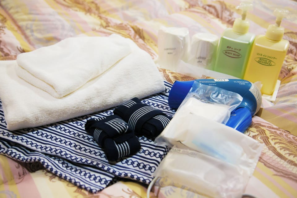 Laptop workspace, bed sheets