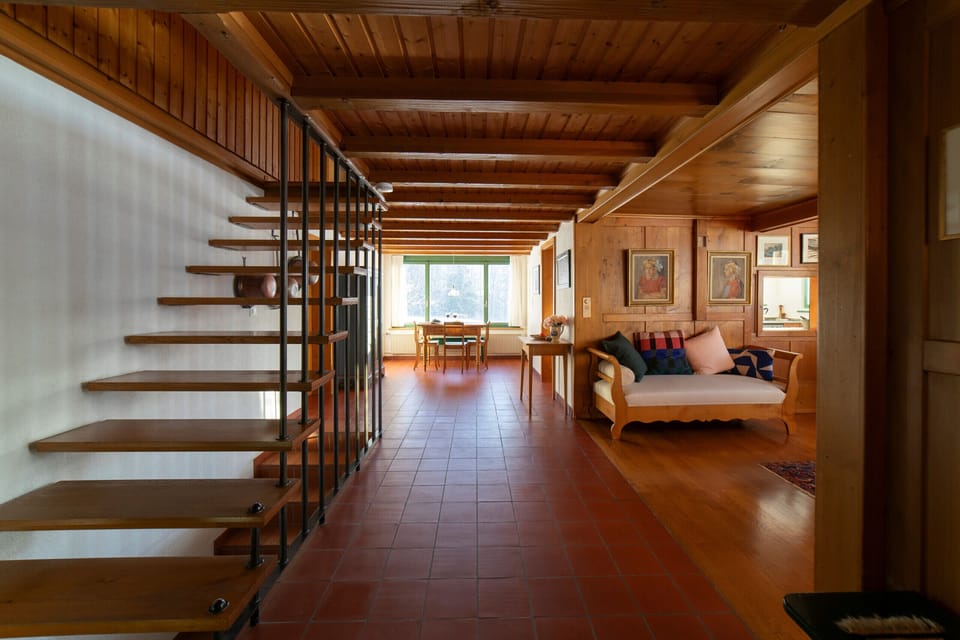 Open living area with staircase, seating area and dining space