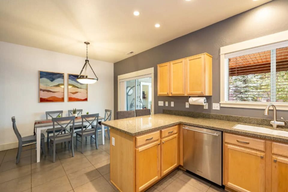 The dining room table is conveniently located next to the kitchen, making meal times easy.
