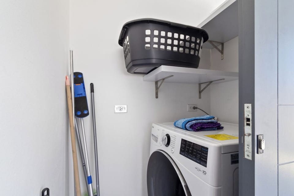 - Laundry room of the home in Oranjestad Aruba
- Modern washer and dryer combo 
- Streamline your laundry routine
- Embrace the convenience of keeping your clothes fresh and clean