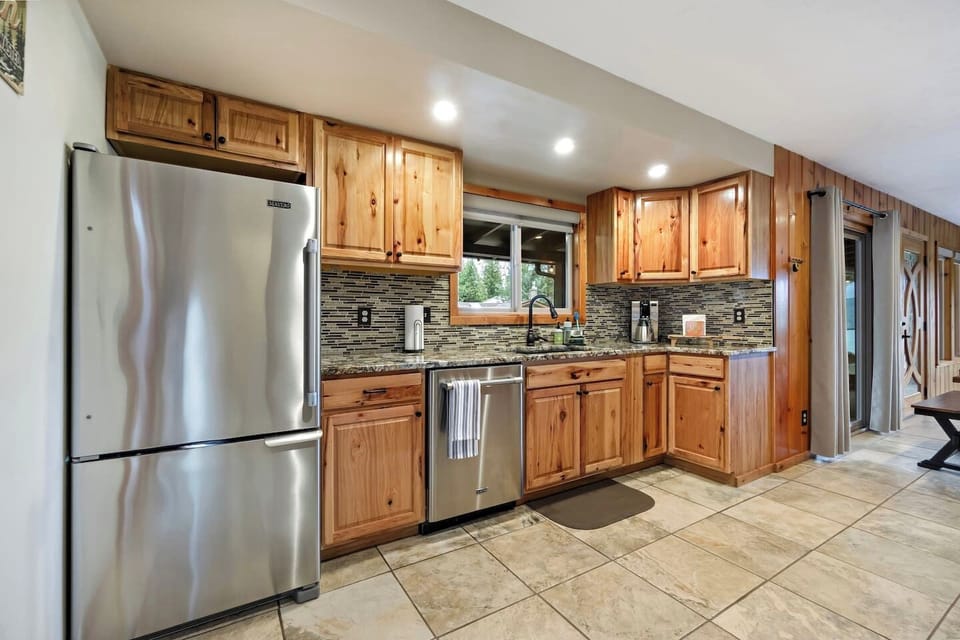Kitchen shows a stainless refrigerator.