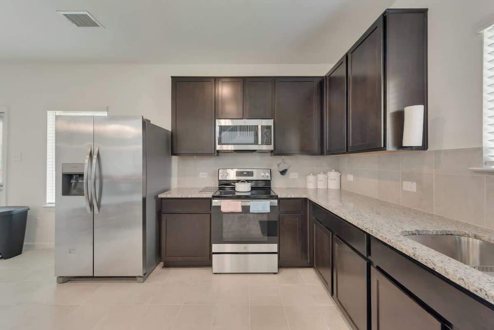 Full Kitchen with Dinning Cooking basics Dishwasher Hot water kettle Microwave Oven Refrigerator Stove Baking sheet Blender Coffee maker Dishes and silverware Freezer Rice maker Toaster Wine glasses Trash compactor