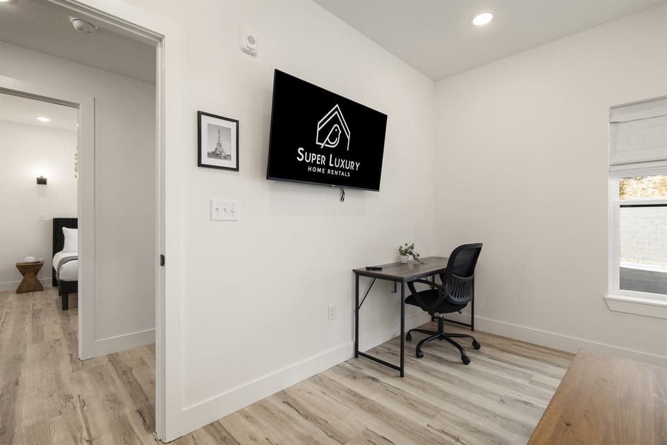 Main Level: Bedroom 1 w/ king bed, desk, & ensuite bathroom