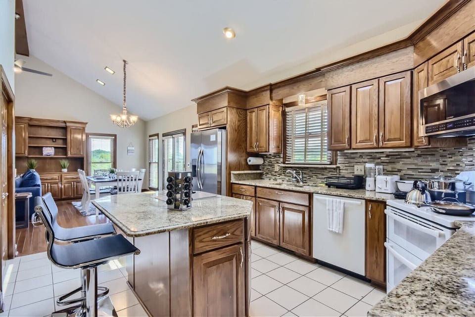 Enjoy the full kitchen with a refrigerator, freezer, oven, stove, microwave, dishwasher, coffee, creamers, mixers, spices, pots, pans, cooking supplies, cutlery, cups, plates, bowls, utensils, small appliances, and many more essentials!