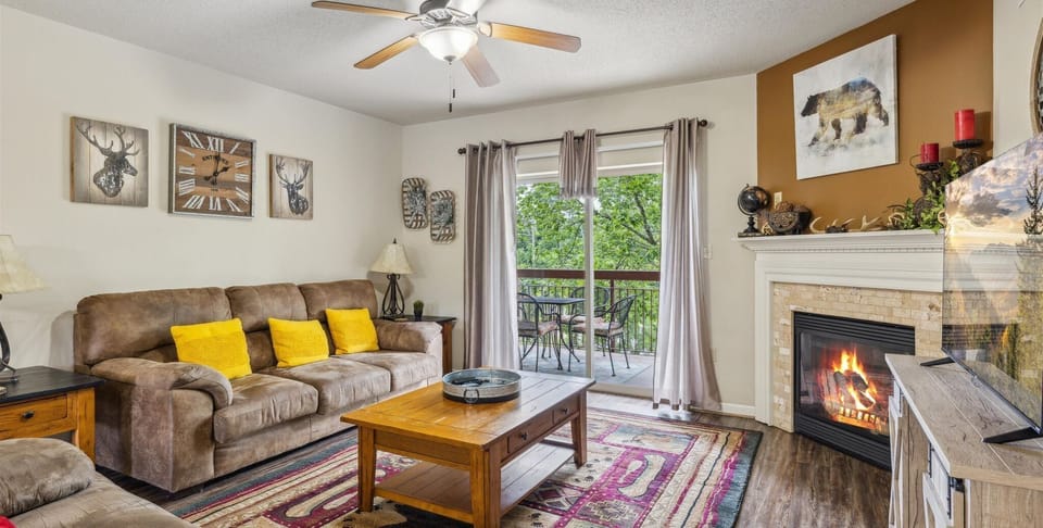 Two Bedroom Condo Pigeon Forge Sleeps 6 on the River Cedar Lodge - Spacious Living Room with Gas Fireplace, Sleeper Sofa and SMART TV with Cable & WIFI throughout vacation rental