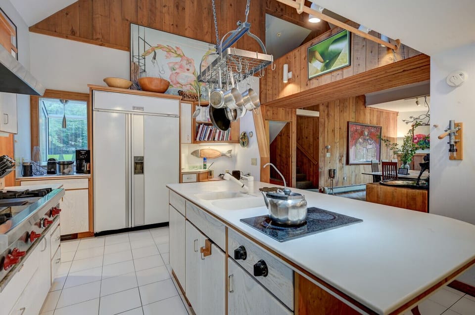 The chef’s kitchen boasts a large center island, the perfect gathering point in this home designed for entertaining