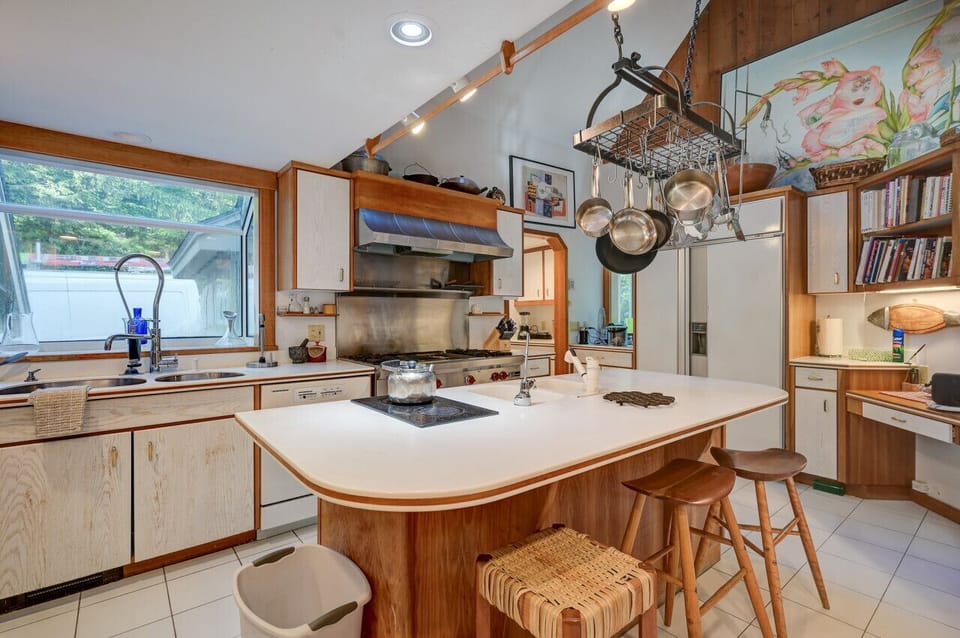 The chef’s kitchen boasts a large center island, the perfect gathering point in this home designed for entertaining