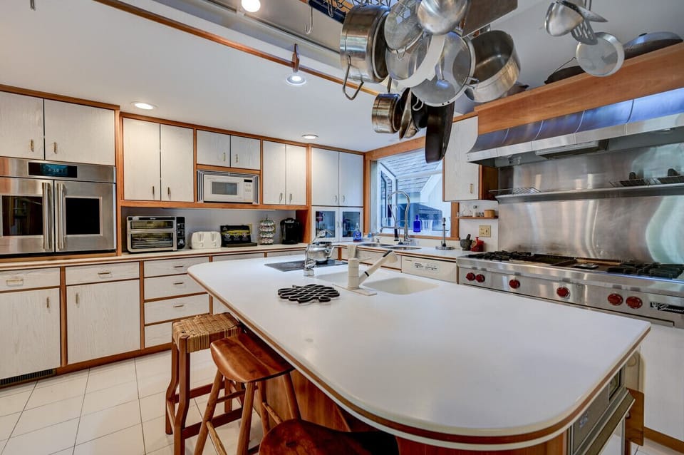 The chef’s kitchen boasts a large center island, the perfect gathering point in this home designed for entertaining