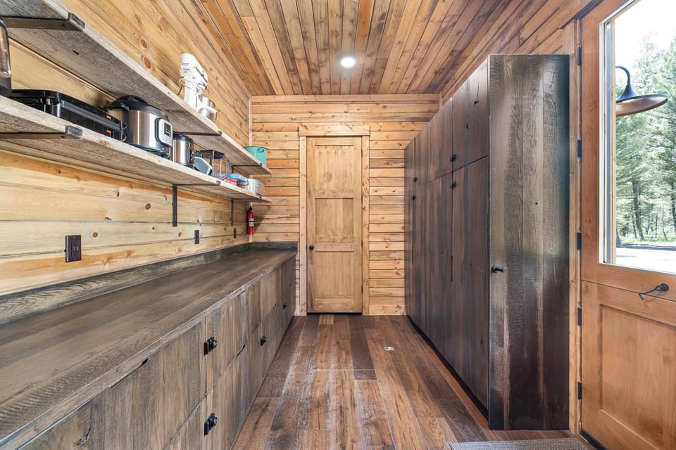 All small appliances are located on the exposed shelves in the laundry room